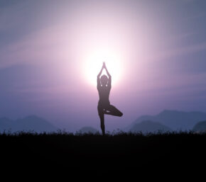 3D render of a female in a yoga pose against a sunset landscape